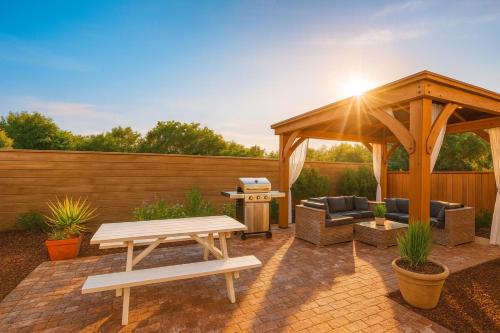 a patio with a wooden gazebo and a picnic table at Fullerton Fairytale Vacation Home - 10 Min Drive to Disneyland in Fullerton