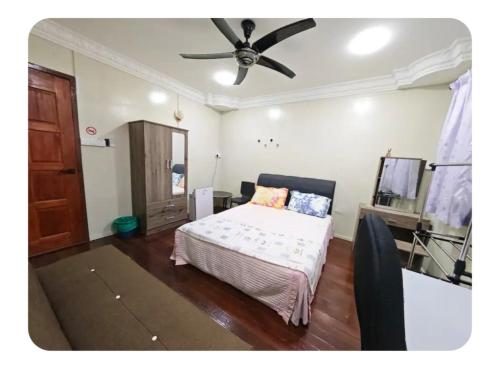 a bedroom with a bed and a ceiling fan at Forest Way Home Sepilok Sandakan in Sandakan