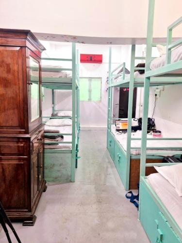 a room with two bunk beds and a dresser at The Nomad cave in Lucknow