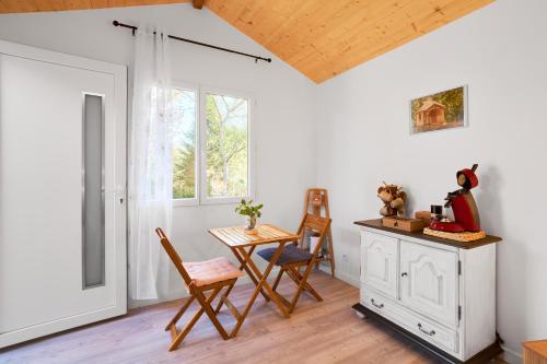 a room with a table and chairs and a window at L'Envol in Eyliac