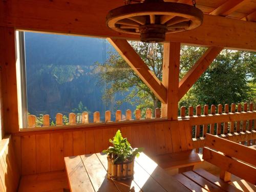 a wooden porch with a table and a window at Raffreiderhof Apt Zirbe in Luson