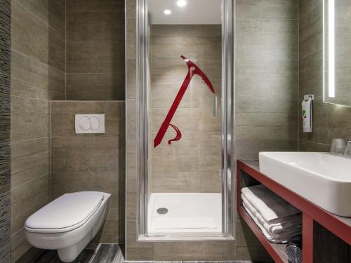 a bathroom with a toilet and a sink at Ibis Styles Sallanches Pays du Mont-Blanc in Sallanches