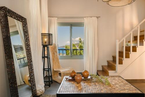 a living room with a mirror and a table at Braunis Horio Villas in Asos