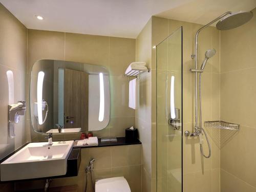 a bathroom with a sink toilet and a shower at ibis Kuala Lumpur City Centre in Kuala Lumpur