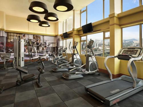a gym with several treadmills and elliptical machines at ibis Kuala Lumpur City Centre in Kuala Lumpur