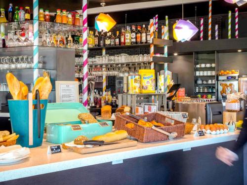 a store with a counter with bread and food on it at ibis Styles Fréjus St Raphael in Fréjus