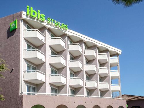 a building with a big sign on top of it at ibis Styles Fréjus St Raphael in Fréjus