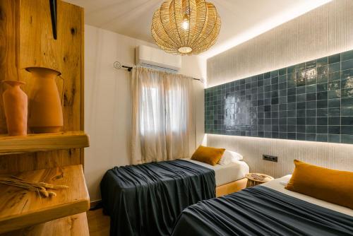 a small room with two beds and a couch at Braunis Horio Villas in Asos