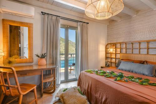 a bedroom with a bed and a desk and a mirror at Braunis Horio Villas in Asos