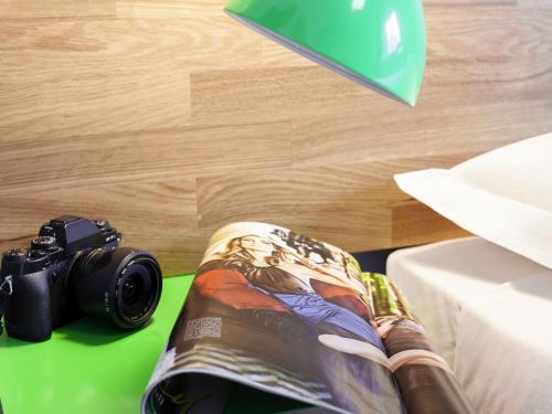 a camera sitting on a table next to a book at Ibis Styles Brindisi in Brindisi