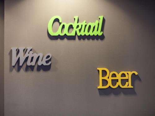 a wall with three different types of logos on it at Ibis Styles Brindisi in Brindisi