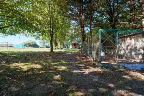 a fence with a goal in a field with trees at L'Envol in Eyliac