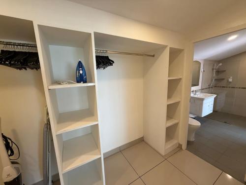 a bathroom with white shelves and a toilet at 2 bedroom pool villa, near Pattaya city centre in Pattaya South