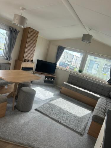 a living room with a couch and a table at 2 Bedroom Caravan 6 Birth The Wolds Ingoldmells Skegness - No pets free WiFi in Ingoldmells