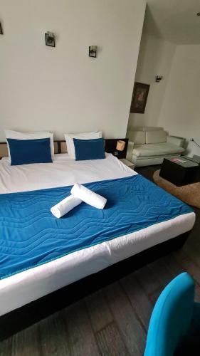 a large bed with two white towels on it at Sokoterme Hotel in Soko Banja