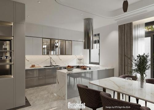 a white kitchen with a table and a dining room at The Quartz Horizon Hanoi-Elegant Hideout with Rooftop Access-Coffee 24-7 in Hanoi