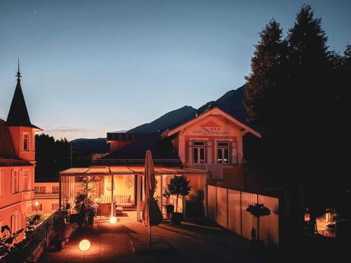 a building with lights in front of a house at Villa Dora Petit Hôtel in Bad Reichenhall