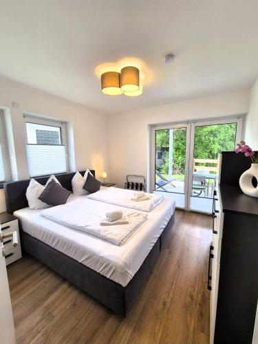 a bedroom with a large bed with white sheets at Winterberg Appartement 21134 in Winterberg