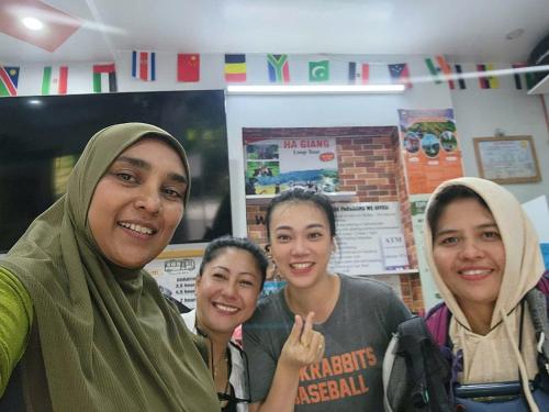 a group of women posing for a picture at Napoli Hostel Cat Ba in Cat Ba