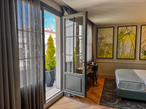 a bedroom with a bed and a large window at The Wings Hotels Pera in Istanbul