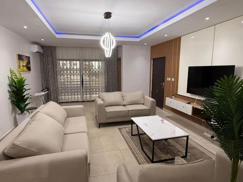 a living room with a couch and a tv at Fohtung Crest in Abuja