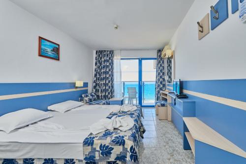 a hotel room with a bed and a window at Palace Hotel - Half Board in Sunny Beach