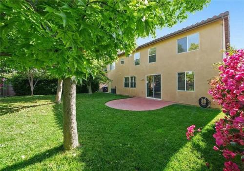 a house with a tree in the yard at #Marbella Lane - Lit & Laid Back Eastvale Home in Corona