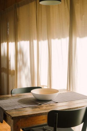 a wooden table with a bowl on top of it at miCielo - Baumhäuser in Vejer de la Frontera