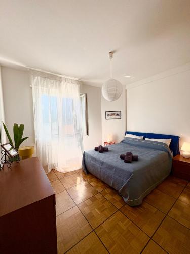 a bedroom with a bed and a large window at Casa Bonomea in Trieste