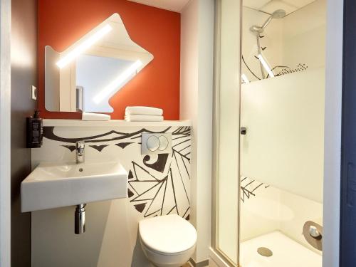 a bathroom with a sink and a toilet at ibis budget Auxerre Centre in Auxerre