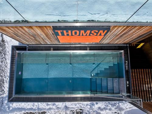 a window in a building with a sign on it at THOMSN Central Hotel & Appartements in Saalbach Hinterglemm