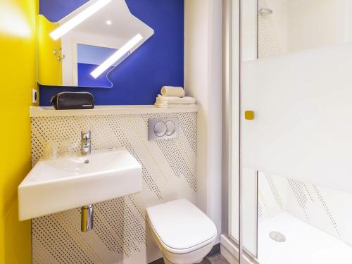 a bathroom with a sink and a toilet at ibis budget Rennes Rte Lorient in Rennes