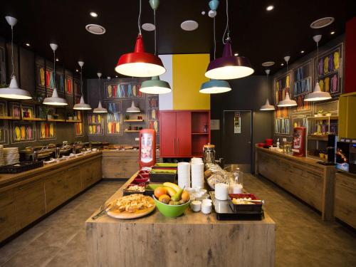 a kitchen with a table with food on it at ibis Vilnius Centre in Vilnius