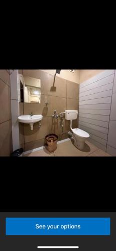 a bathroom with a toilet and a sink at Rocks beach house in Kannur