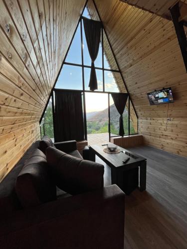 a living room with a couch and a large window at Green Garden 