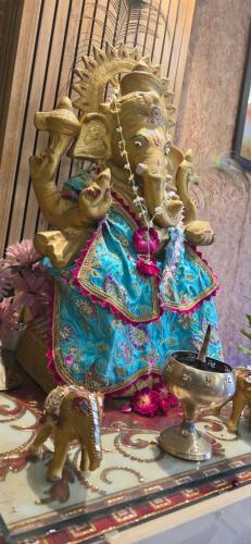 a statue of a deity sitting on a table at New Shanti Hotel in Prayagraj