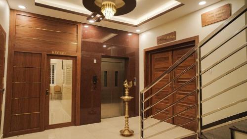 a walk in closet with wooden doors and a ceiling at Ganesh Residency 