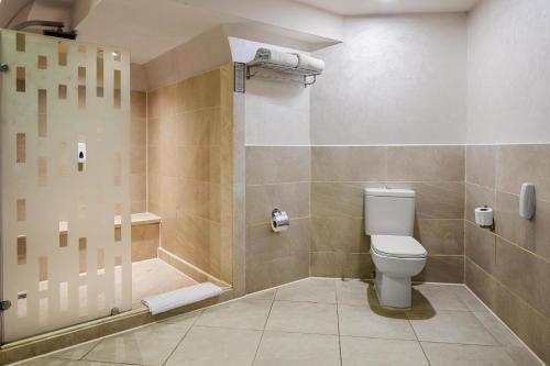 a bathroom with a toilet and a shower at Pickalbatros Citadel Resort Sahl Hasheesh in Hurghada