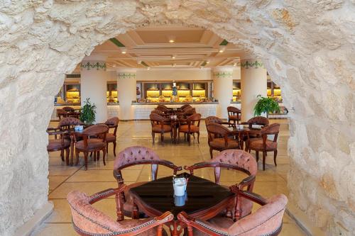 a view of a restaurant with tables and chairs at Pickalbatros Citadel Resort Sahl Hasheesh in Hurghada