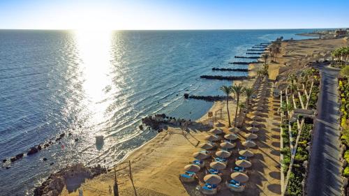 an aerial view of a beach with umbrellas and the ocean at Pickalbatros Citadel Resort Sahl Hasheesh in Hurghada