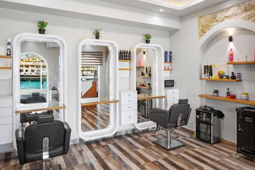 a hair salon with two mirrors and two chairs at Pickalbatros Citadel Resort Sahl Hasheesh in Hurghada