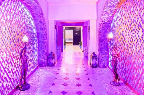 a hallway with purple walls and a hallway with lights at Pickalbatros Citadel Resort Sahl Hasheesh in Hurghada