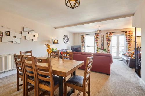 a dining room and living room with a table and chairs at Host & Stay - Harbour View House in Whitby
