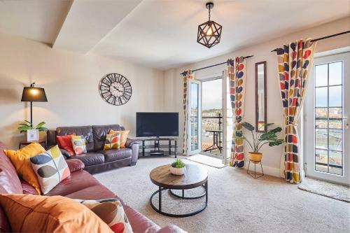 a living room with a couch and a tv at Host & Stay - Harbour View House in Whitby