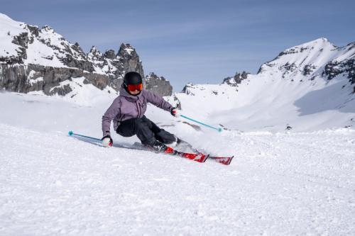 a person is skiing down a snow covered mountain at Casa Partnun 2-9 in Laax-Murschetg