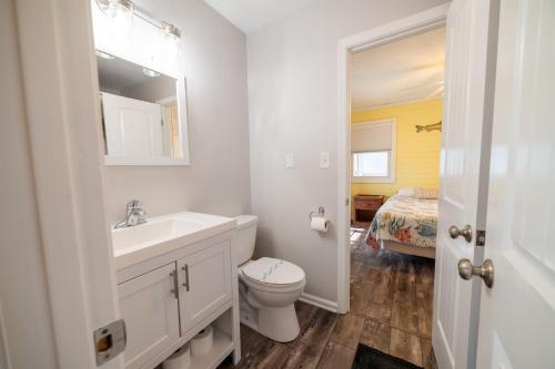 a white bathroom with a sink and a toilet at Genesis On The Water, Views! Views! Views! in Rodanthe