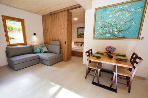 a living room with a table and a couch at House Elipsa in Bovec
