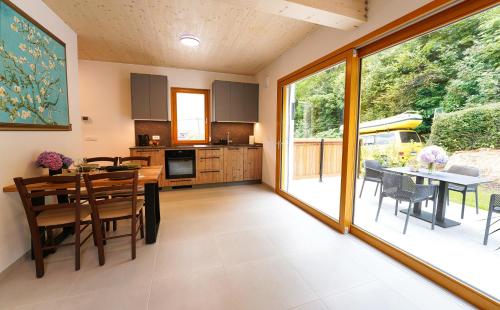 a kitchen and dining room with a table and chairs at House Elipsa in Bovec