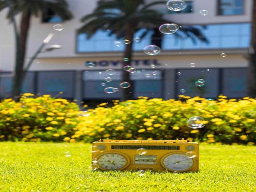 a radio sitting on the grass in the grass at Novotel Mohammedia in Mohammedia