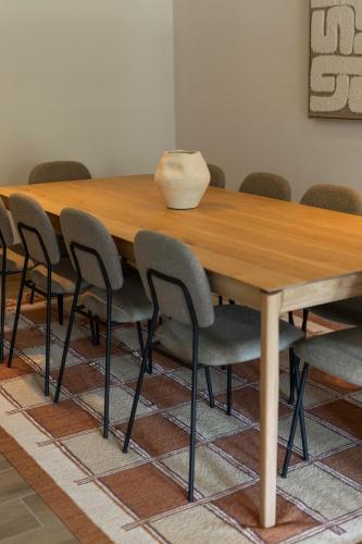 a conference room with a wooden table and chairs at La Barzalière in Chimay